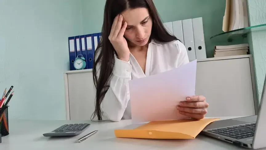 Žena držící nervózně dopis.